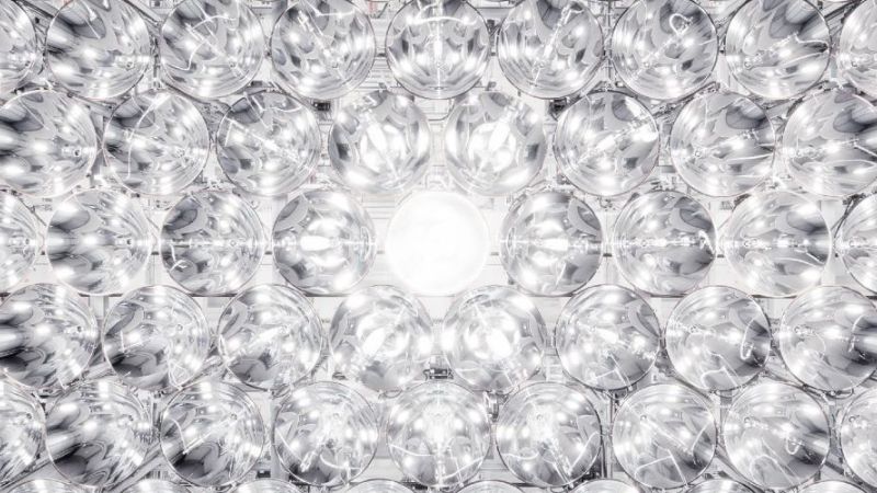 The cover image shows a wall of spotlights in the 